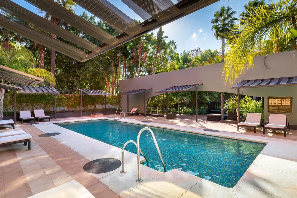 Outdoor pool area with sun loungers at the Marbella hotel