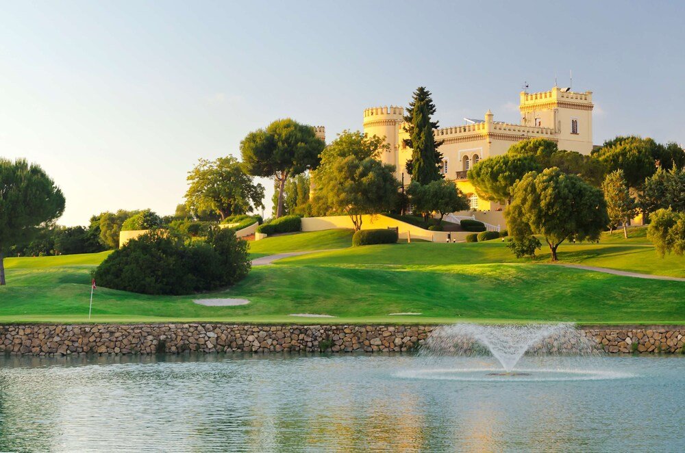 Castle-style hotel building with moat and fountain