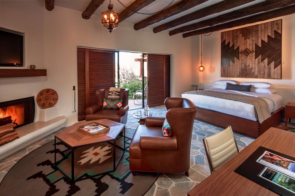 Spacious room with a large bed and a fireplace