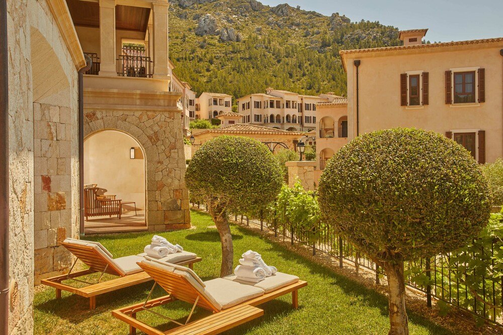 Courtyard with lounge chairs at the hotel in Capdepera