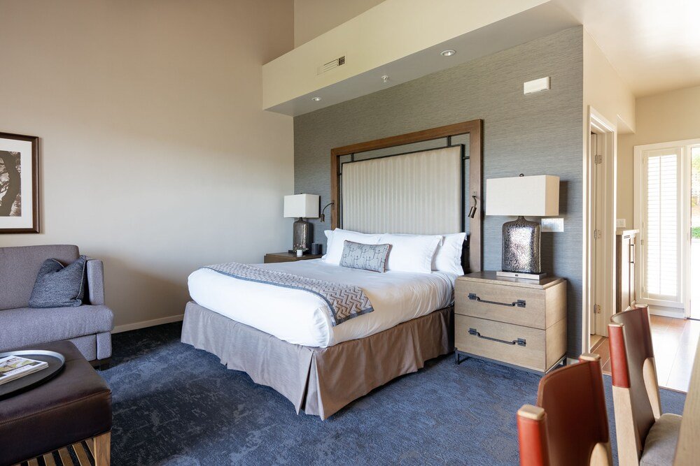 Hotel room with a large bed and a bedside table