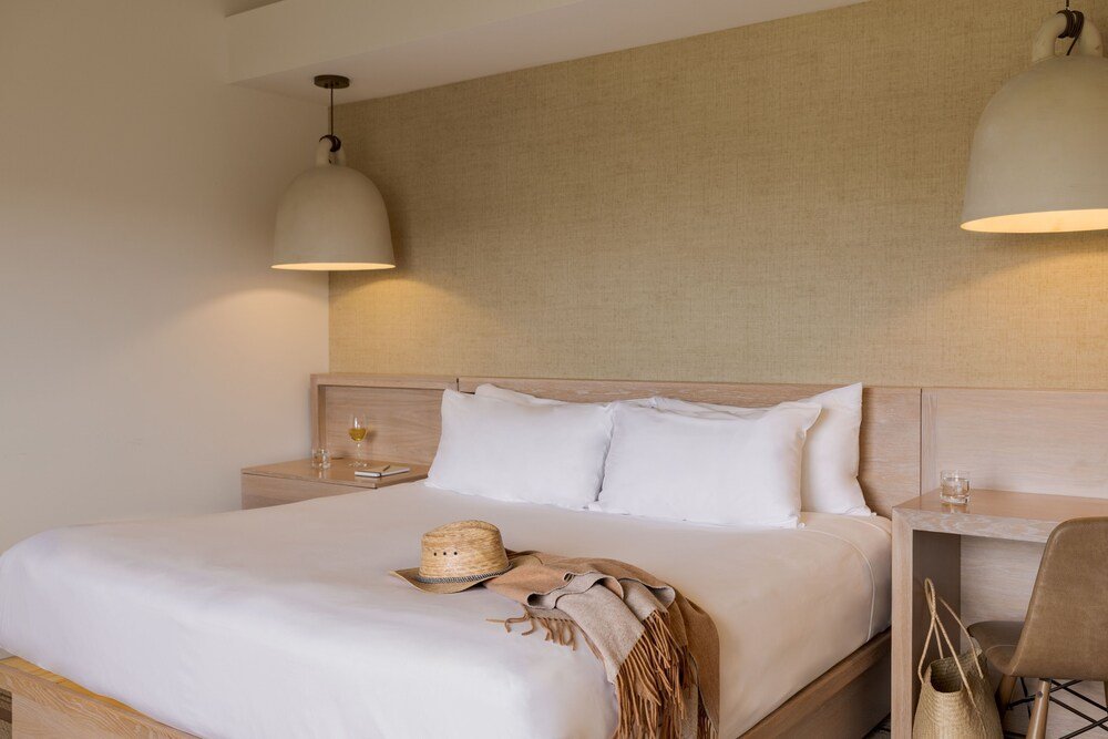 Neatly made bed with white linens at Carmel Valley Ranch, California