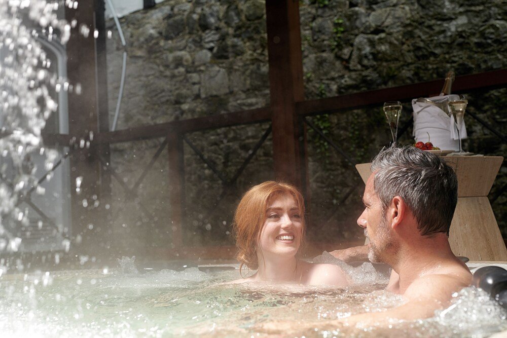 Couple relaxing in a hot tub at Dromoland Castle, County Clare
