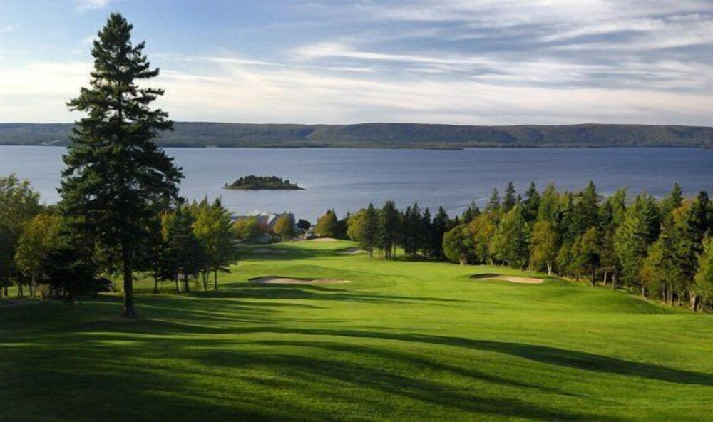 Golf course with a large body of water in the distance