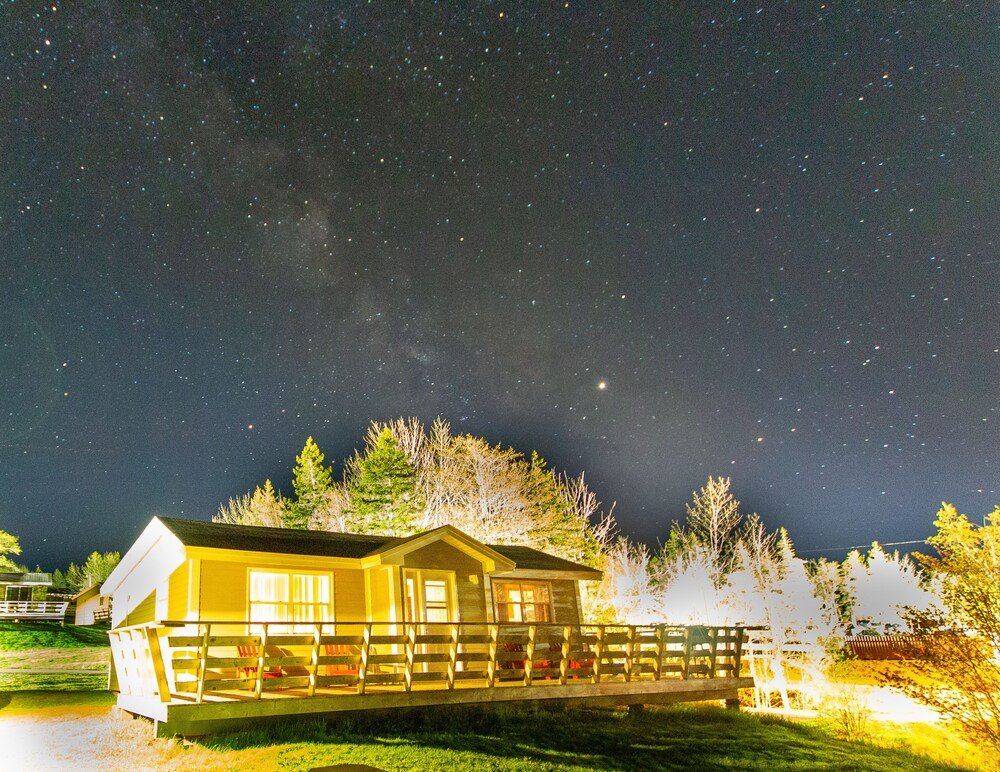 Wooden cabin with a porch and fenced area