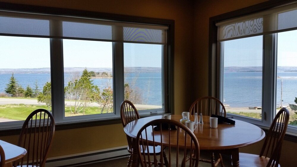 Dining area with a table, chairs and large windows