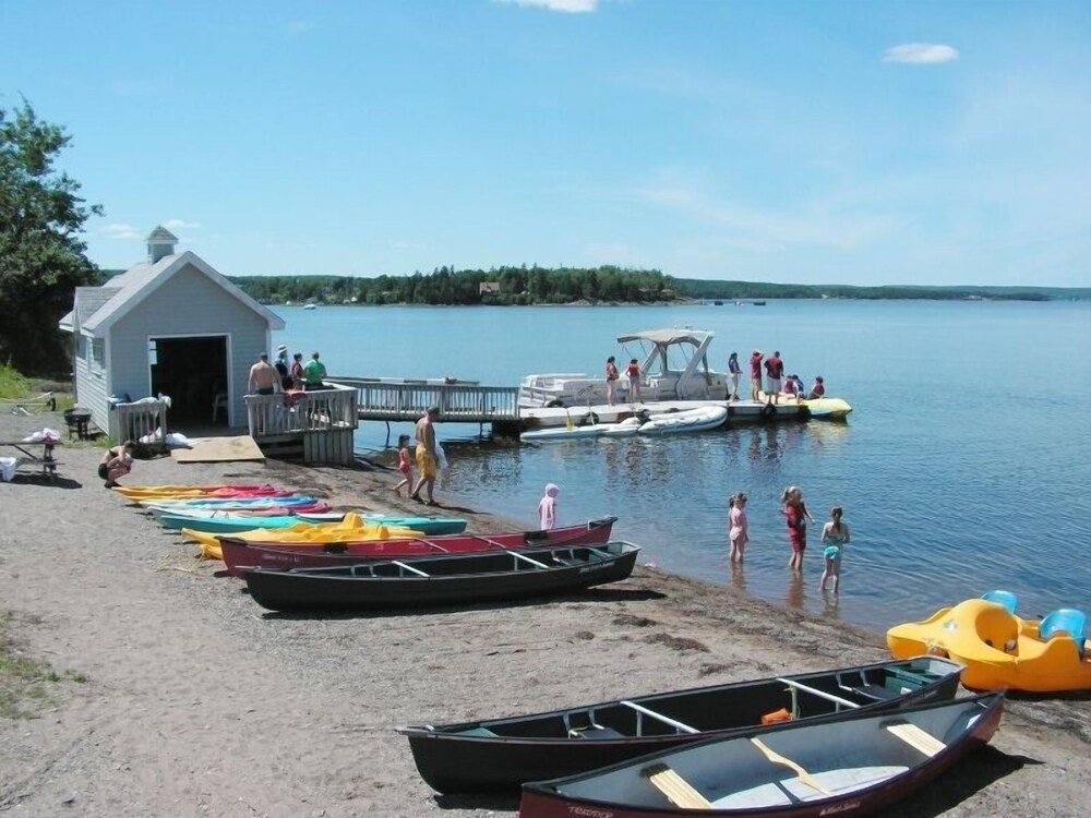 Lakeside dock with canoes and a small shed