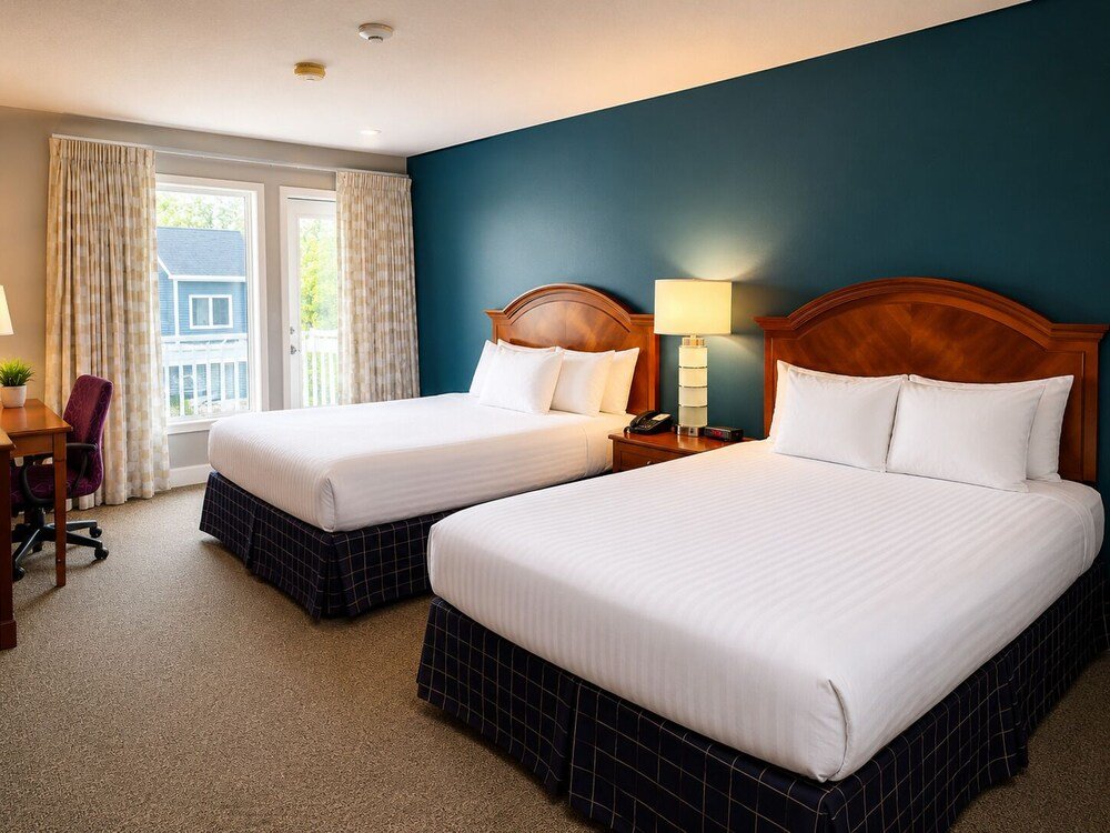 Hotel room with two beds and a desk