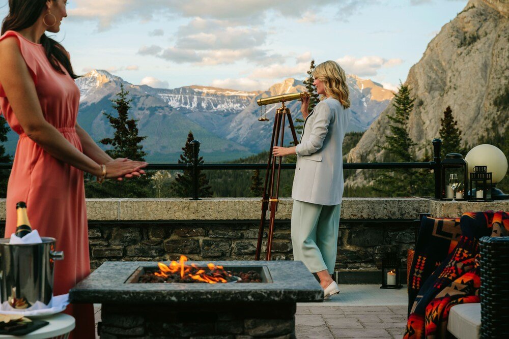 Terrace with a stone fireplace and a telescope