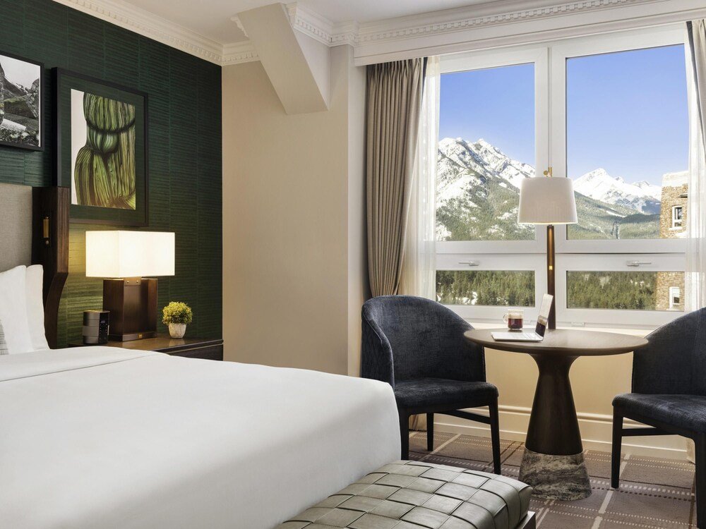 Hotel room with a bed and two chairs