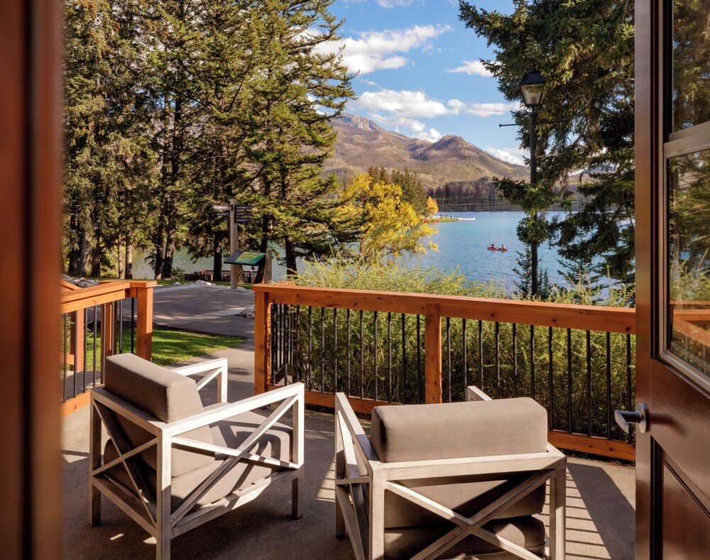 Balcony with two chairs and a wooden railing