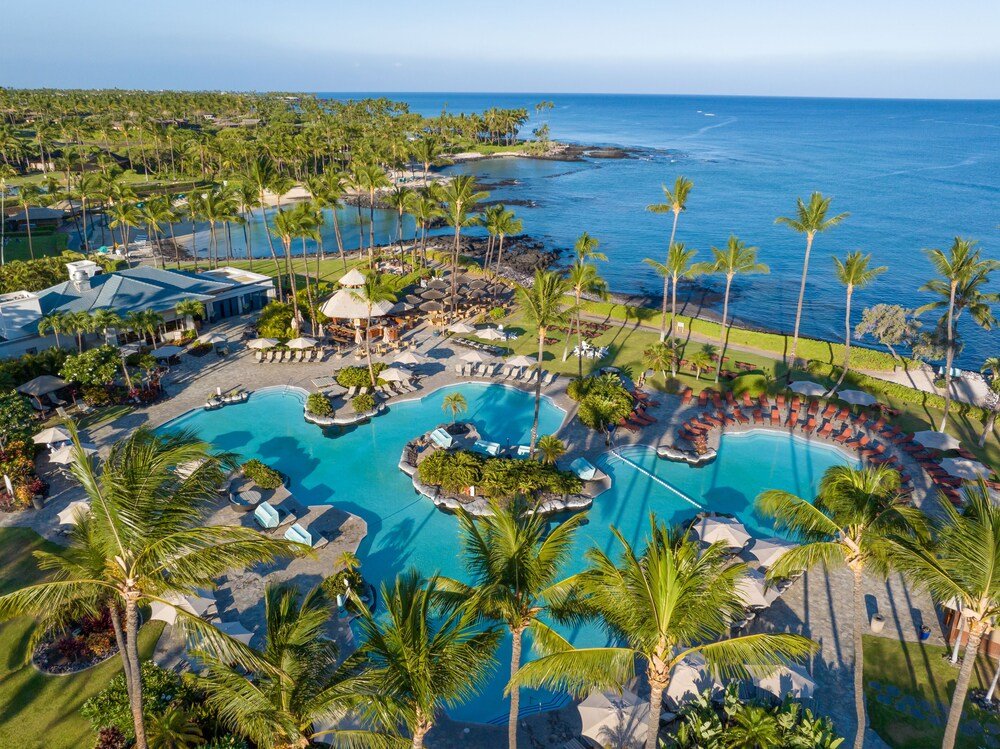 Resort with a large pool and palm trees