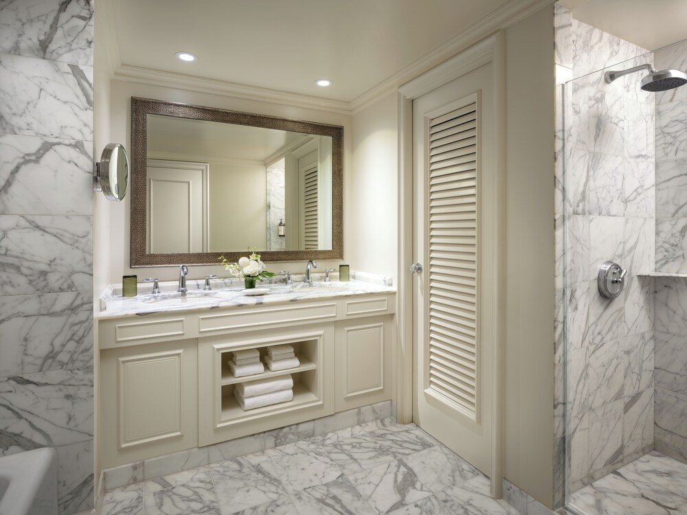 Bathroom with a marble floor and a double sink