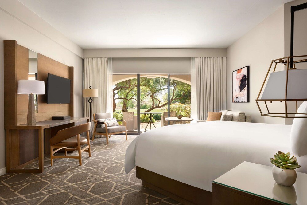 Hotel room with a large bed and a desk