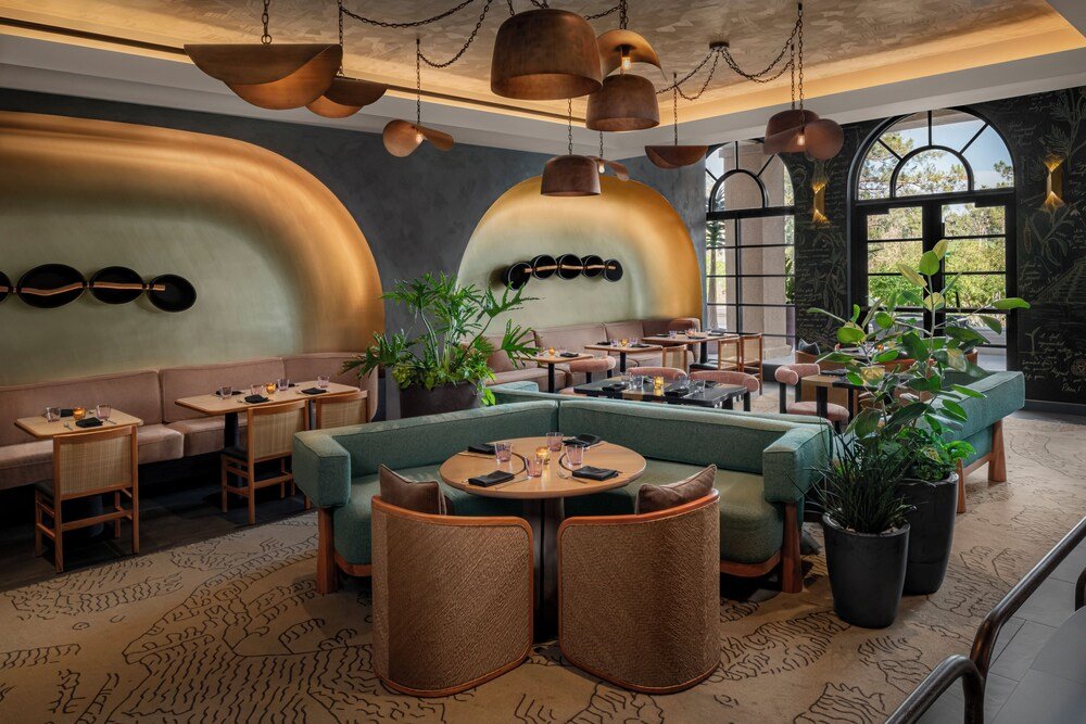 Restaurant with round tables and soft lighting at the resort
