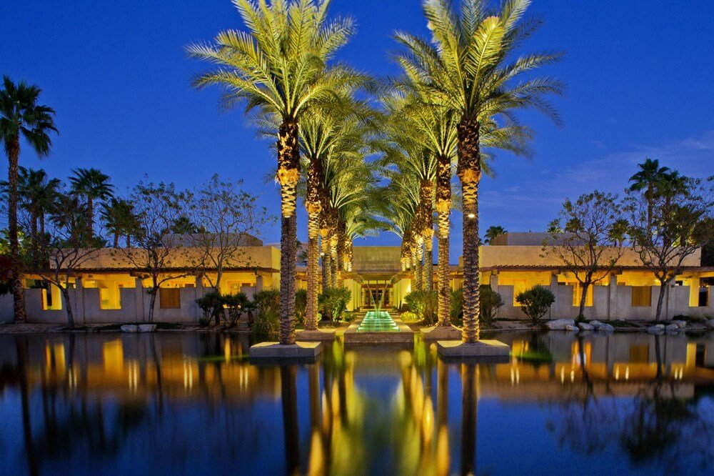 Resort pool with palm trees and hotel building