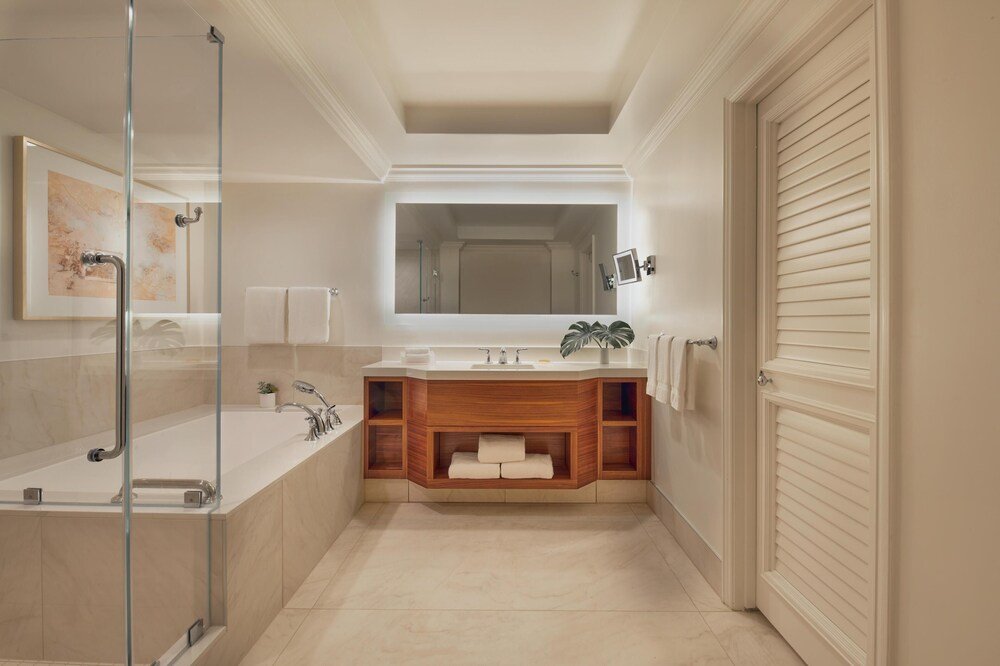 Modern bathroom with a glass shower enclosure at the resort
