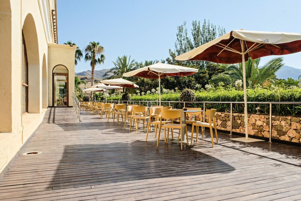 Outdoor patio with seating at Hotel Envía Almería Spa & Golf
