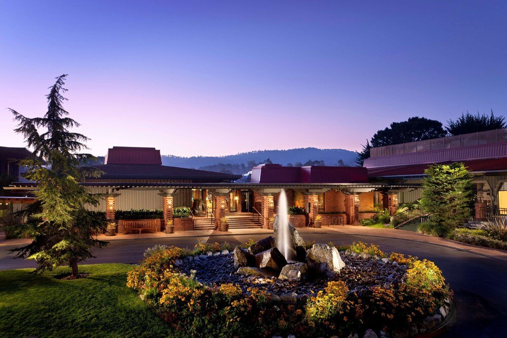 Hotel front with a waterfall feature at the resort