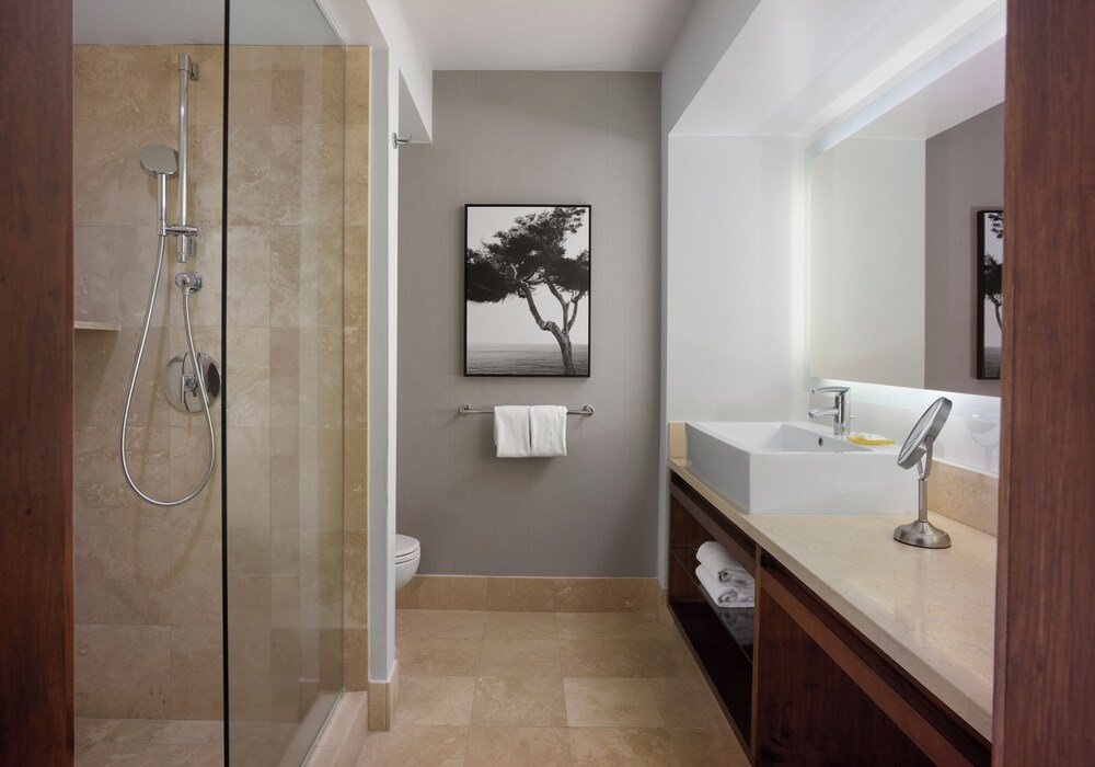 Modern bathroom with a glass-enclosed shower at the resort
