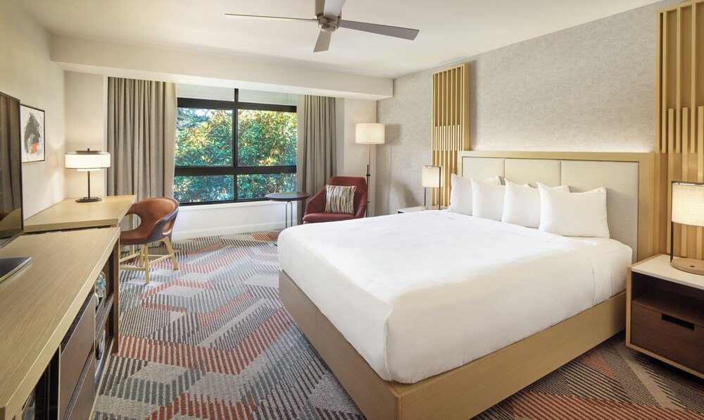 Hotel room with a bed, desk and chair