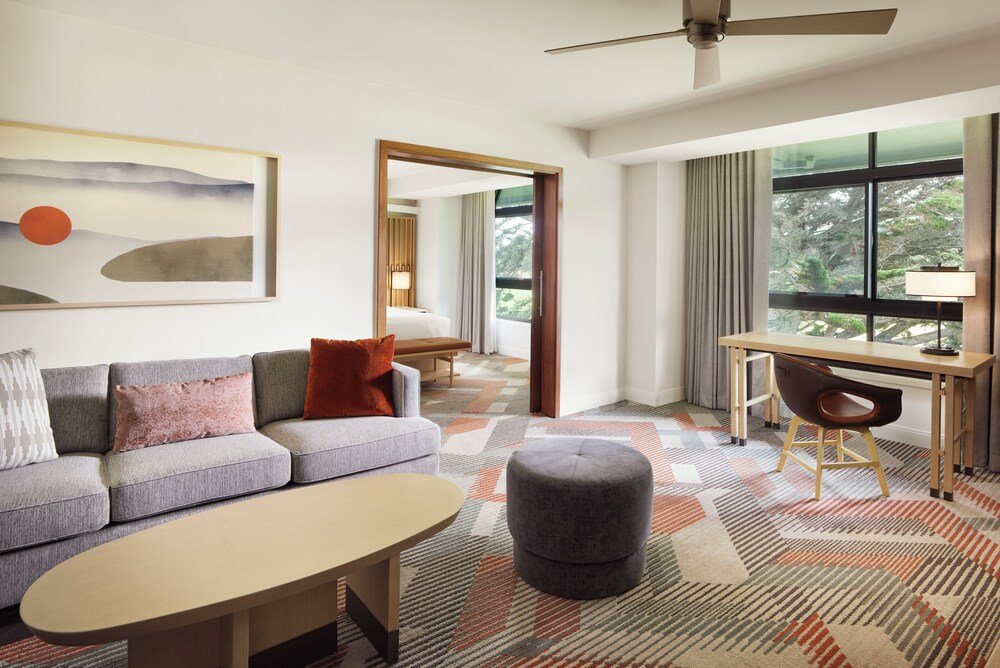Modern hotel room with a sofa and ottoman