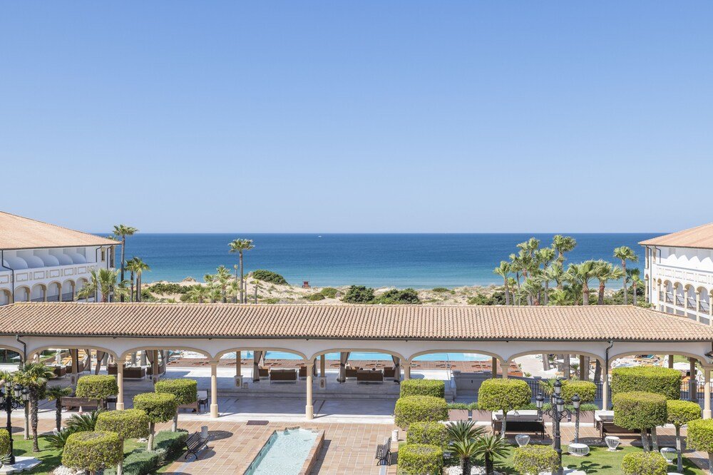 Resort pool with sun loungers at Iberostar Selection Andalucía Playa
