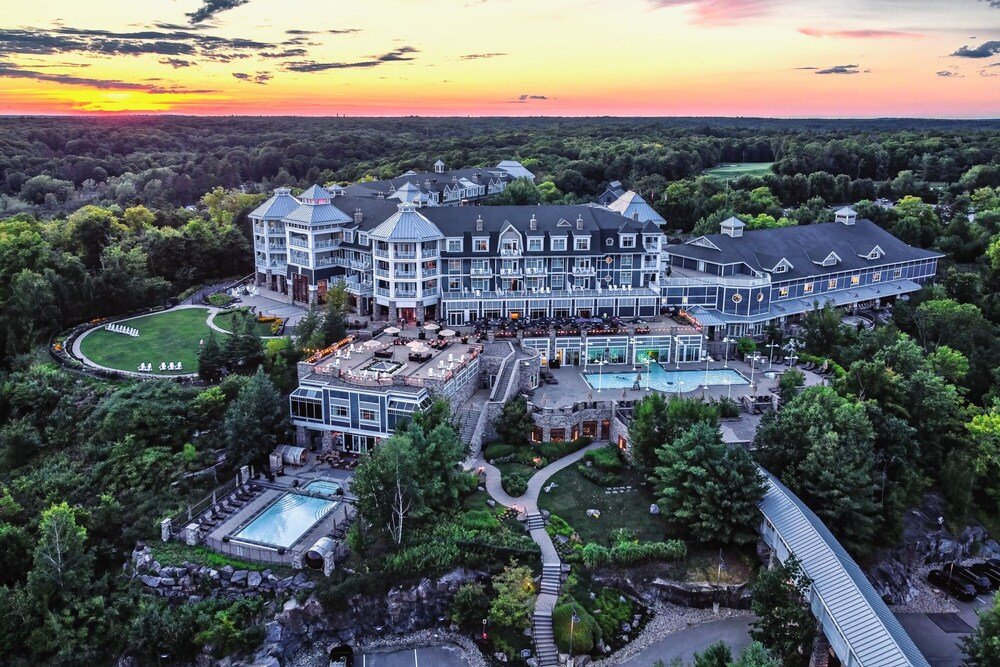 Large multi-storey hotel with a pool and landscaping