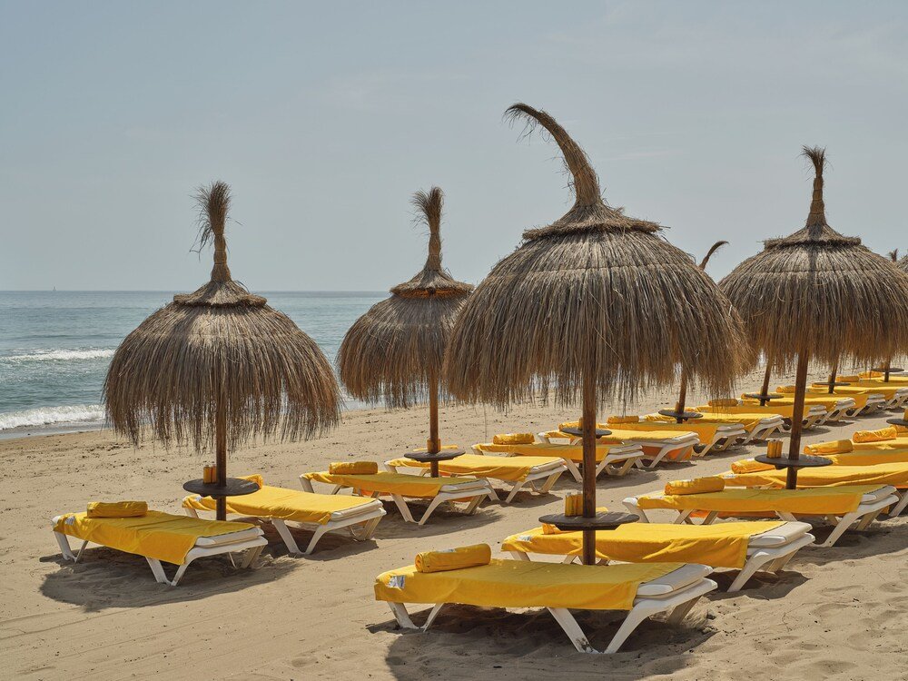 Beach with sun loungers near Kimpton Los Monteros Marbella
