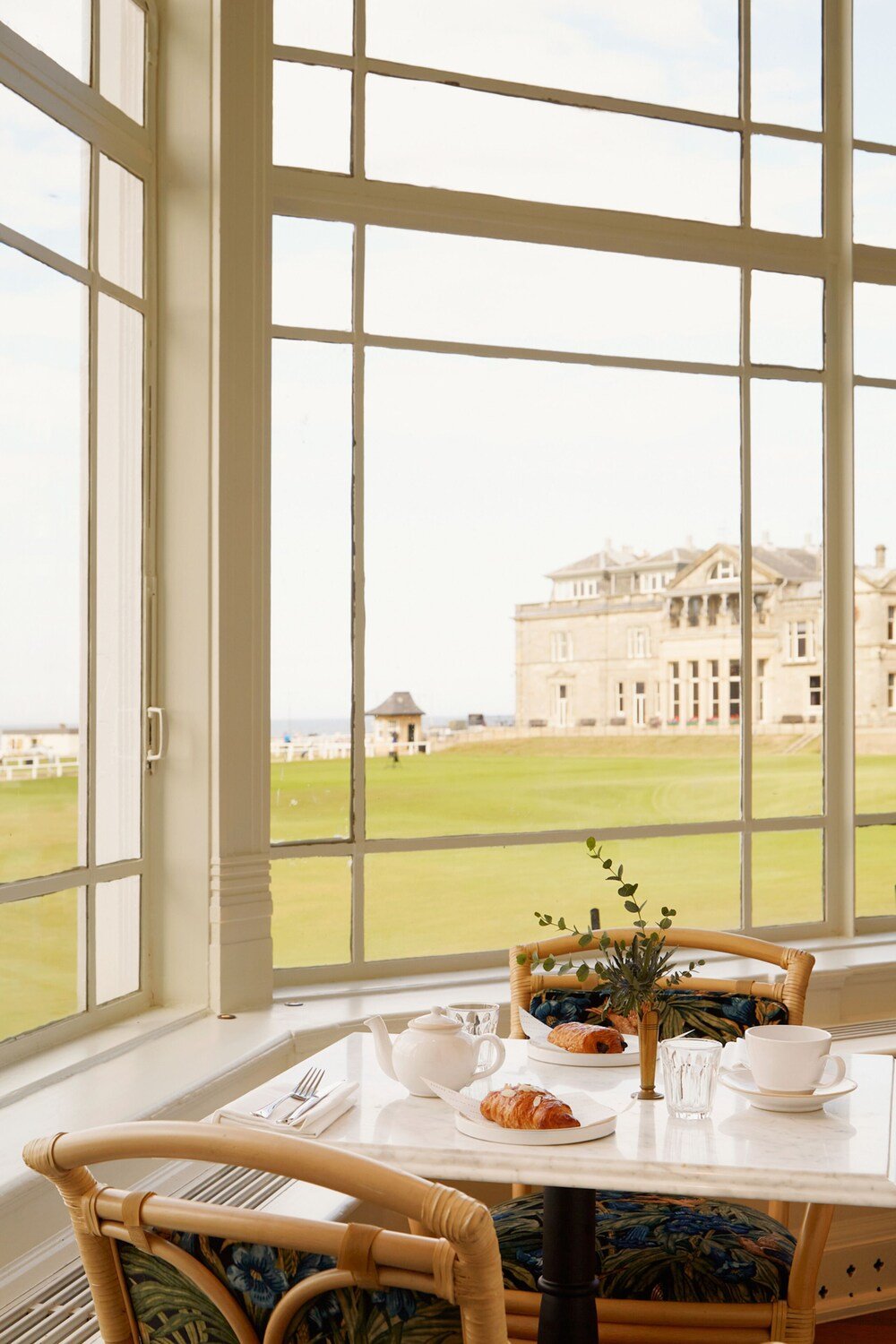 Breakfast table by a window with a view of the hotel