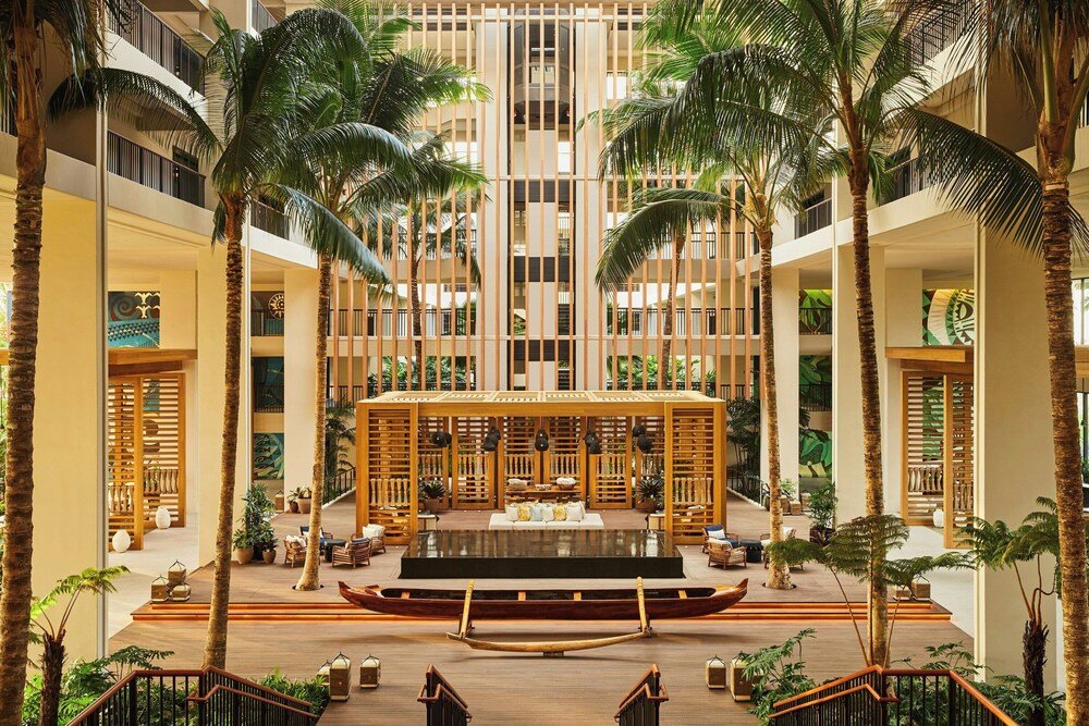 Spacious resort atrium with a central seating area for guests