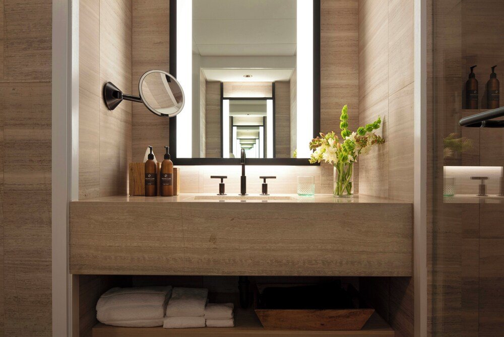 Modern bathroom in a resort room with a large mirror