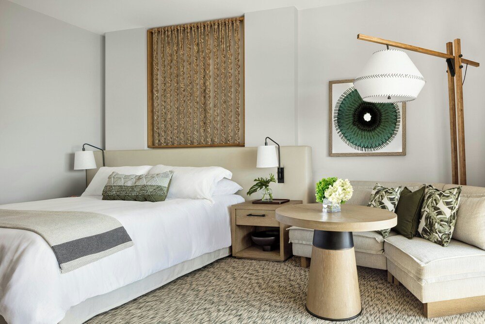 Hotel room with a bed, bedside table and lamp