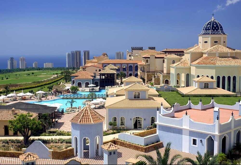 Resort swimming pool surrounded by sun loungers at Meliá Villaitana, Benidorm