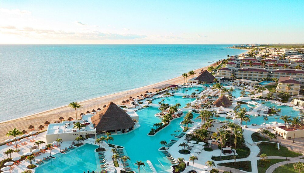 Resort buildings overlooking a large swimming pool at Moon Palace