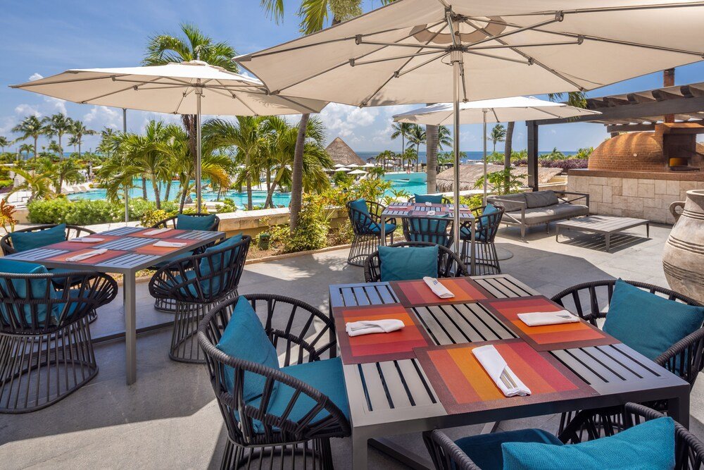 Outdoor patio area with several tables at the resort