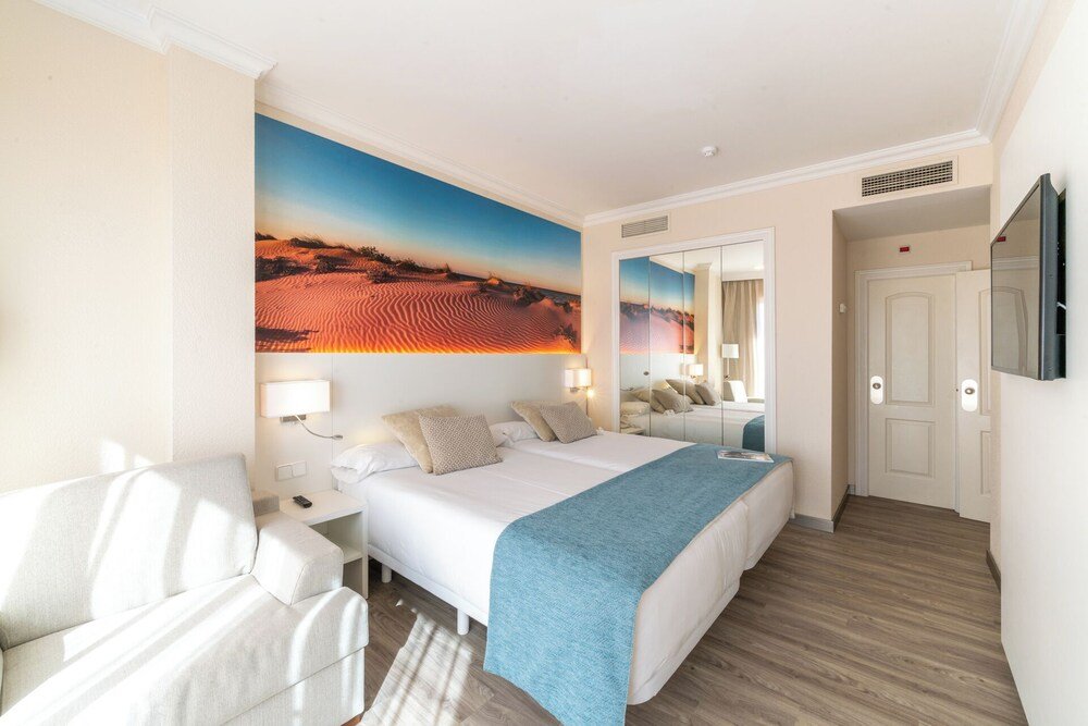 Hotel room with a tidy bed and bright interior