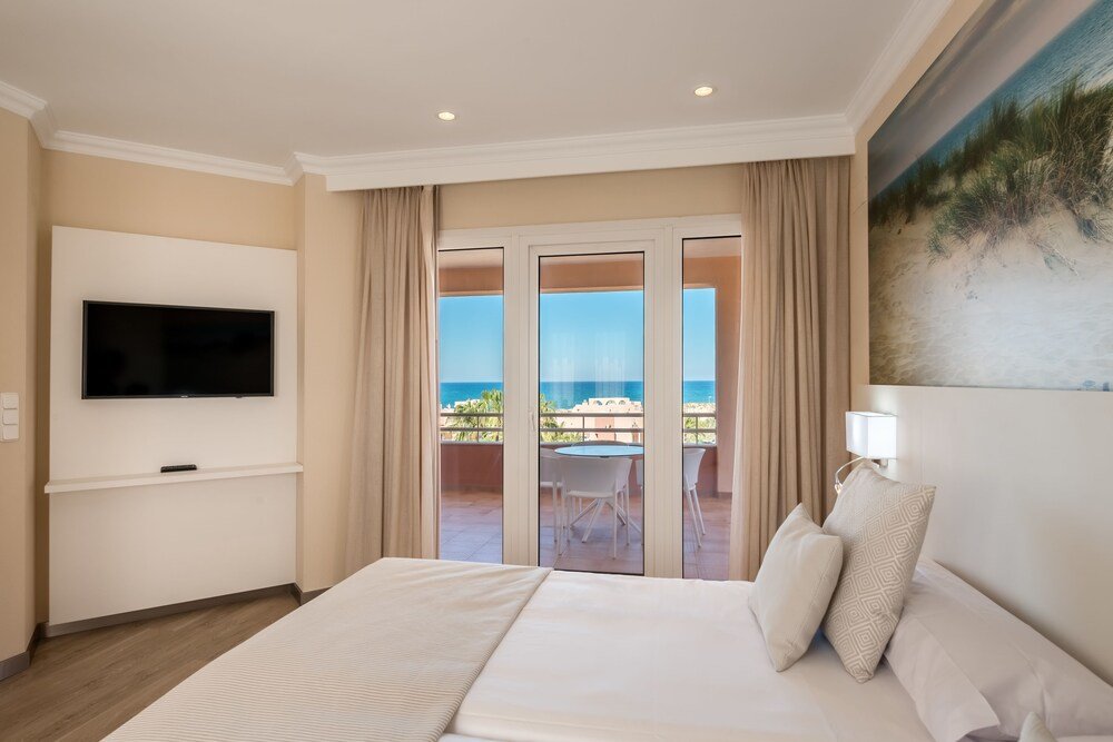 Hotel room with a large bed at the Oliva resort