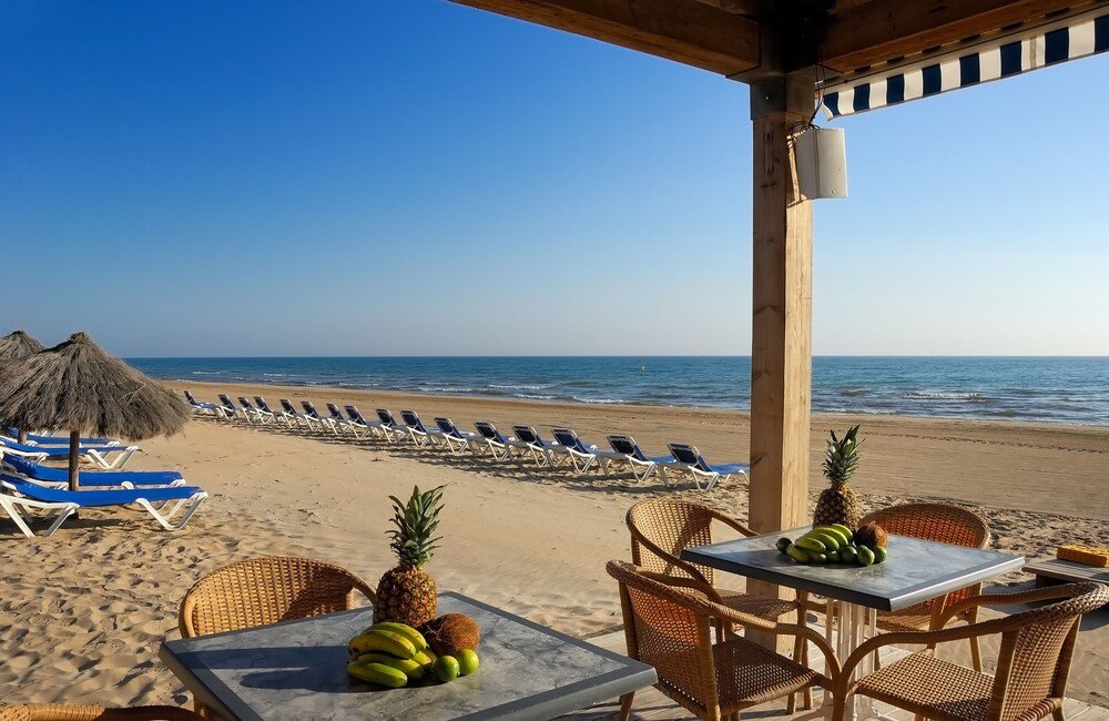 Beachside patio with tables at the hotel in Oliva, Spain