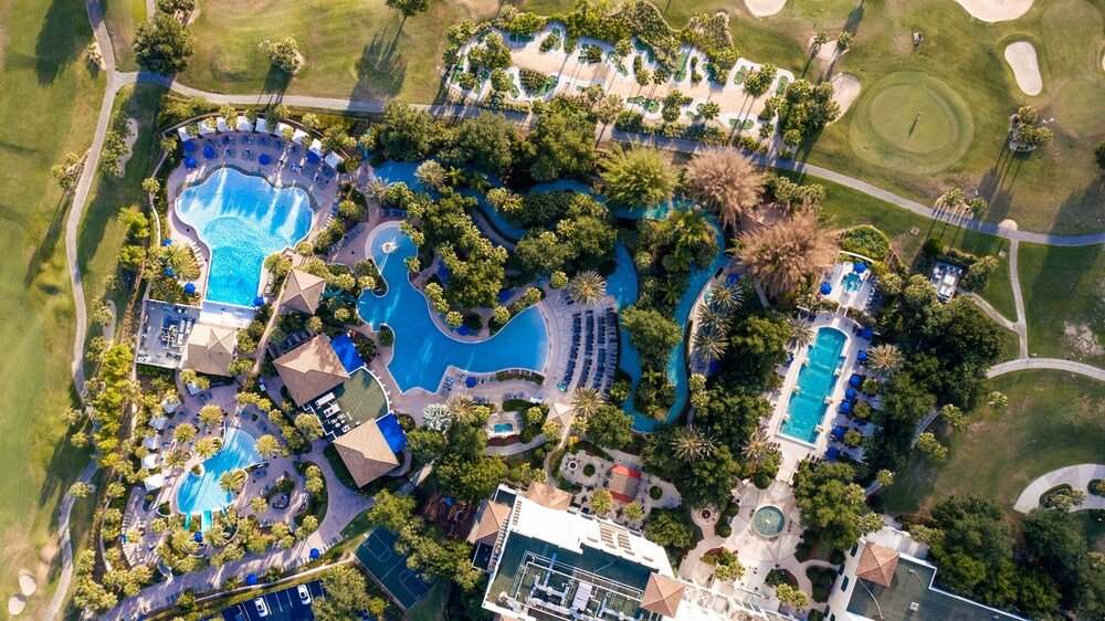 Aerial view of a resort with several swimming pools