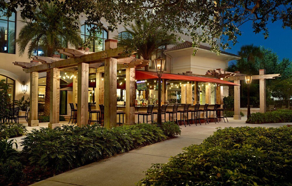 Outdoor restaurant terrace covered by wooden pergolas at the resort