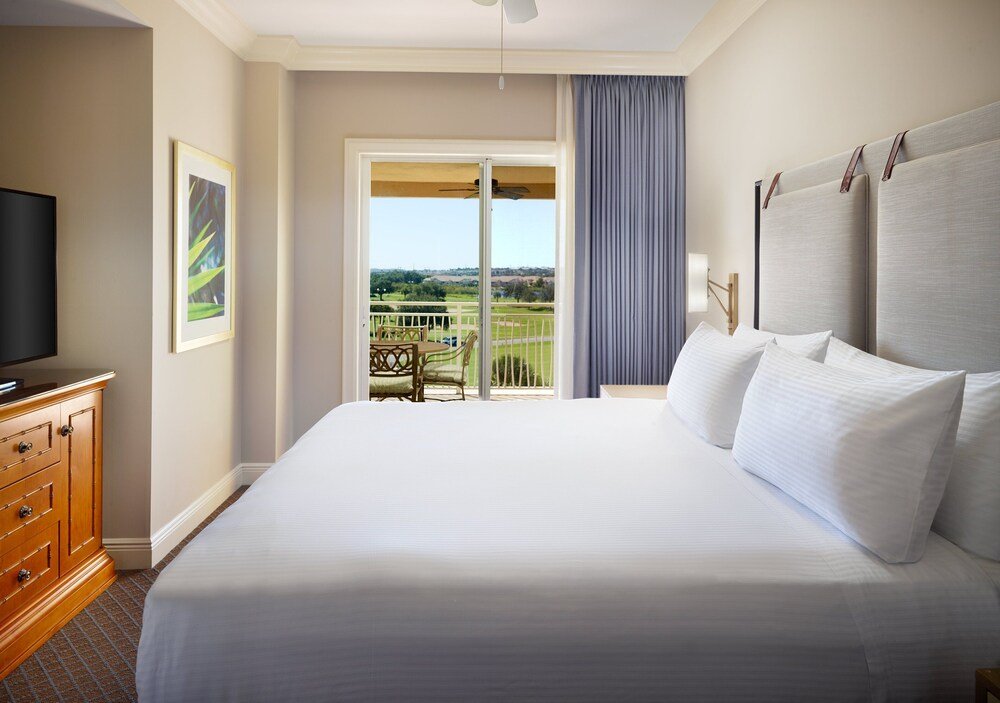 Hotel room with a large bed and a television