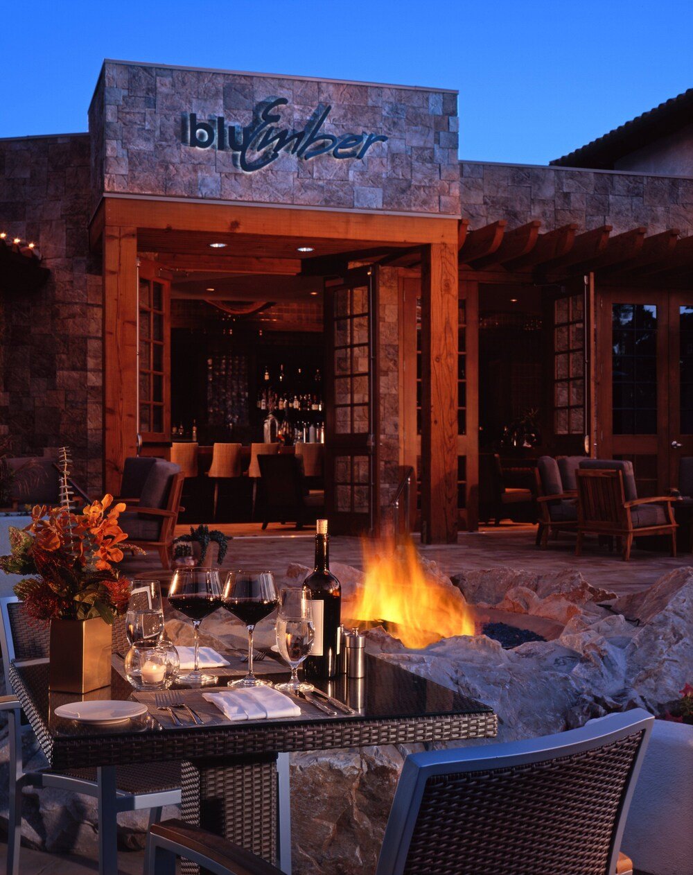 Outdoor seating area arranged around a fire pit at the resort