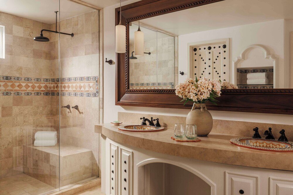 Guest bathroom with a glass-enclosed shower at the resort
