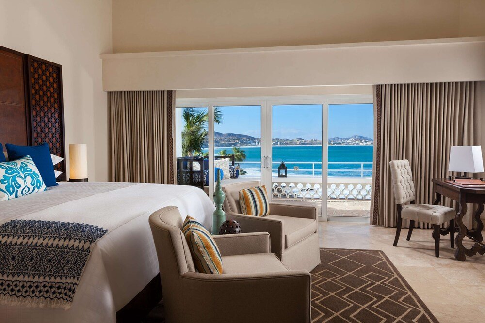 Hotel room with a bed and soft furnishings at the resort