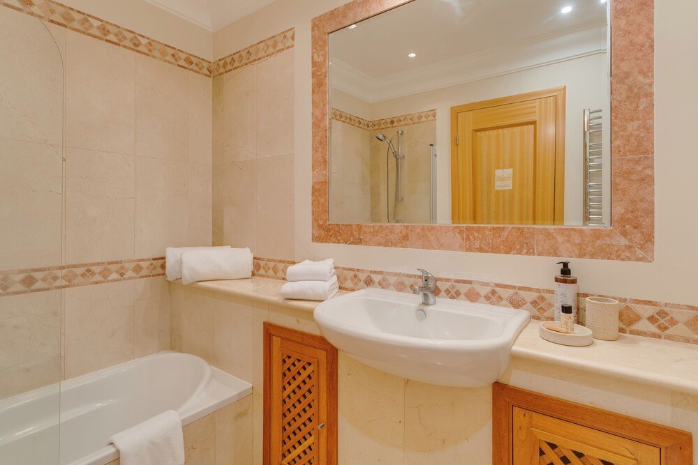 Bathroom with a bathtub in an apartment at Palheiro Village in Funchal, Madeira