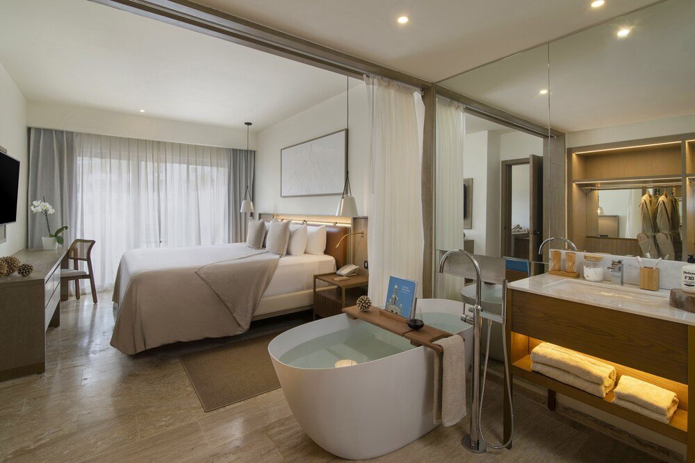 Modern hotel room with seating area at Paradisus Palma Real in Bávaro, Punta Cana