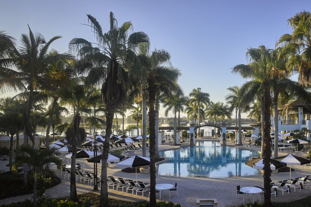 Resort pool area with lounge chairs and umbrellas