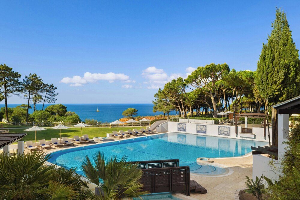 Swimming pool with loungers at Pine Cliffs Resort in Albufeira, Algarve