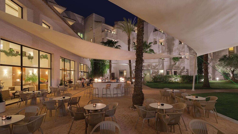 Outdoor dining area with tables at the resort in Cartaya, Huelva
